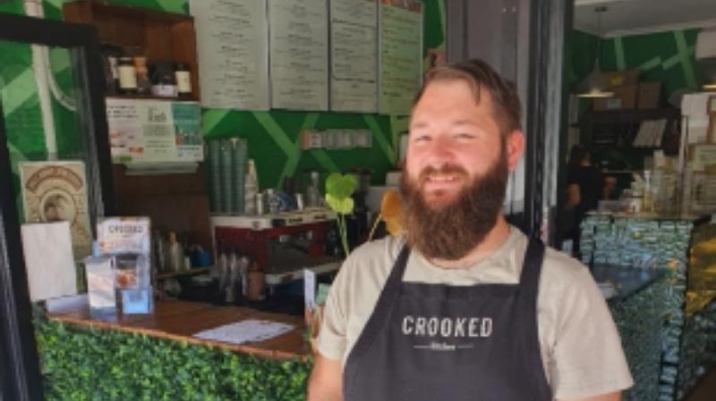 Owner of Crooked Kitchen standing in front of the cafe.