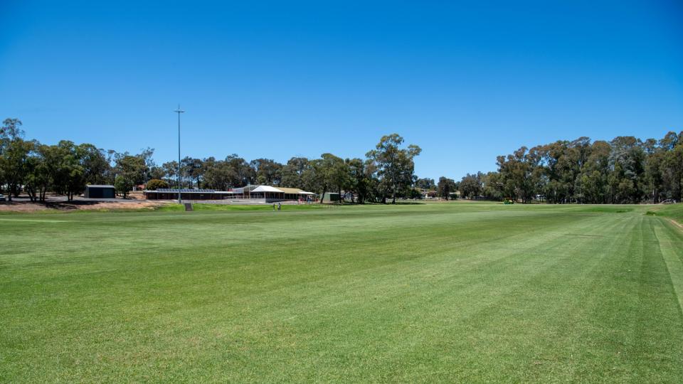 Grass pitch and building at Strathdale Park Sports Precinct