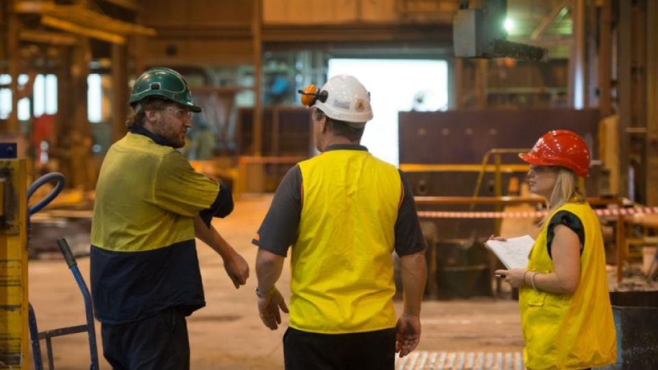 People in discussion at a manufacturing facility