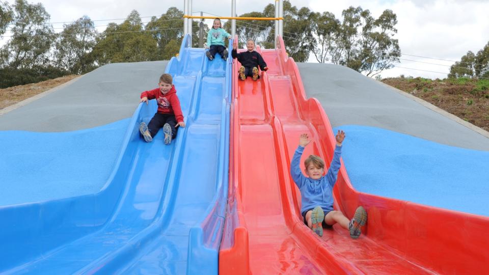 Kids on New Slides at Park
