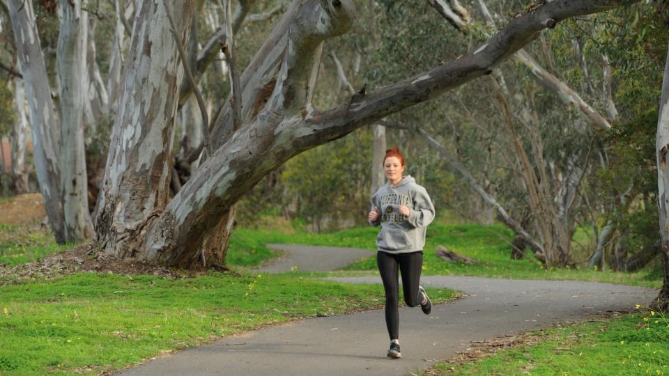 Woman Running in Spring Gully Reserve
